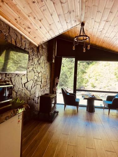 a living room with a stone wall at Ayder Luxury Villas & Bungalows in Çamlıhemşin