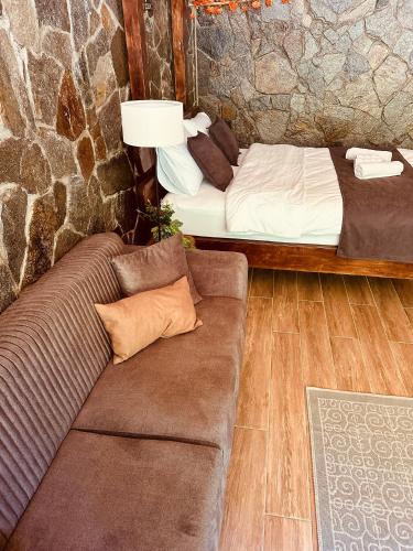 a living room with a couch and a bed at Ayder Luxury Villas & Bungalows in Çamlıhemşin