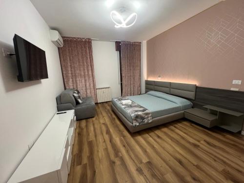 a bedroom with a bed and a flat screen tv at Amo Venice in Venice