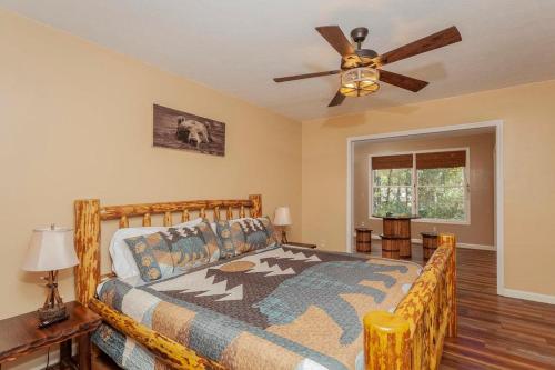 a bedroom with a bed and a ceiling fan at Bear Cabin-3 BR 2 Bath with Indoor Hot tub-one level-FREE Pool Pass-Pet welcome in McGaheysville
