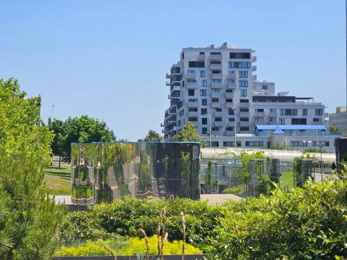 a view of a garden with a building in the background at Sun Prague - Stodůlky in Prague