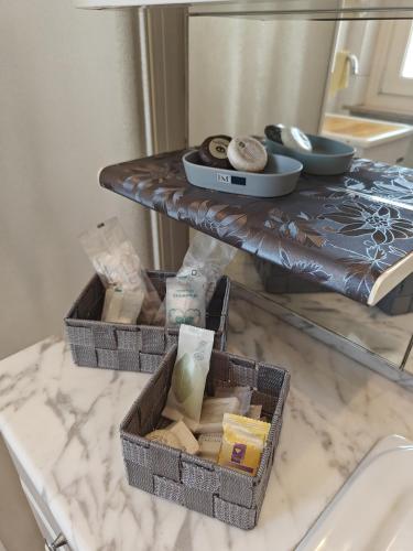 two baskets on a table with soap and cheese at Casa Vacanza Torino Stadio in Turin