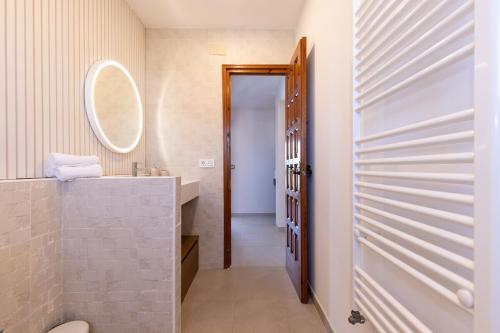 a bathroom with a sink and a mirror at Villa Carmen - Peaceful Eco-Luxury with private pool in Cunit