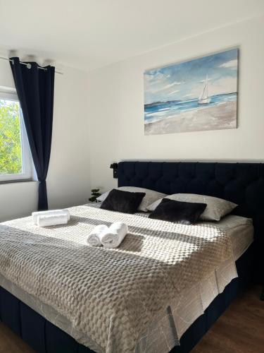 a bedroom with a bed with two towels on it at Apartments Silenzio in Stari Grad