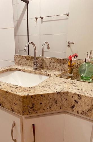 a bathroom counter with a sink and a mirror at Apto Suite Aconchegante a 03 minutos do Bairro Horto in Coronel Fabriciano