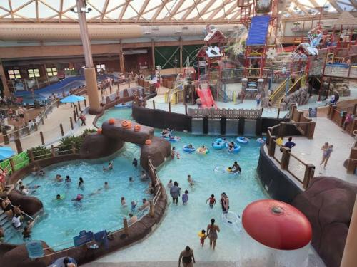a group of people in an indoor water park at Bear Cabin-3 BR 2 Bath with Indoor Hot tub-one level-Pool Pass-Pet welcome in McGaheysville