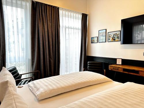 a hotel room with a bed and a television at Designhotel Central Fulda in Fulda