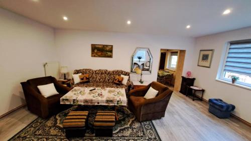 a living room with a table and two chairs at Zofia in Struga