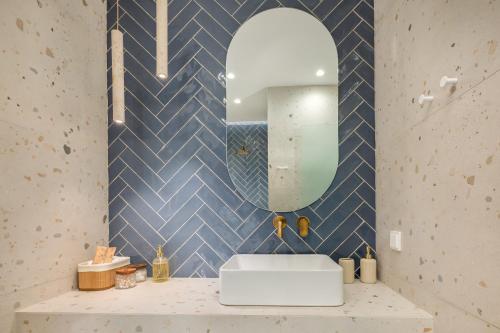 a bathroom with a sink and a mirror at Secret Garden Studios in Mytilini