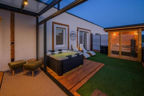 a room with a tub in the middle of a yard at Tatra Horizon apartment & Private Wellness in Poprad