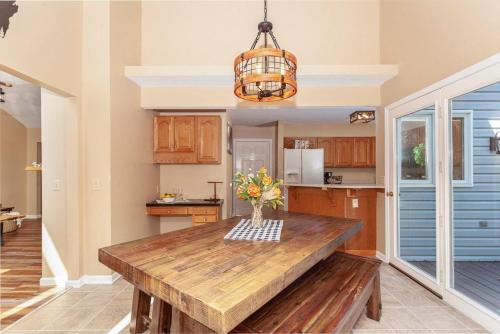 a kitchen with a wooden table with a vase of flowers at Bear Cabin-3 BR 2 Bath with Indoor Hot tub-one level-Pool Pass-Pet welcome in McGaheysville