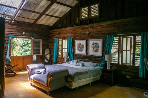 a bedroom with a bed and a chair at 3BR Riverside Secret Retreat in Jarabacoa