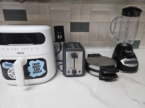 a kitchen counter with a blender and a toaster at 5 BR House with heated pool near DFW and stadium in Grand Prairie