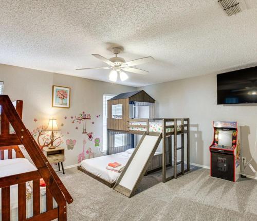 a bedroom with a bunk bed and a play room with a ceiling at 5 BR House with heated pool near DFW and stadium in Grand Prairie