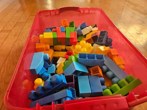 a red tray filled with legos on a wooden floor at 5 BR House with heated pool near DFW and stadium in Grand Prairie