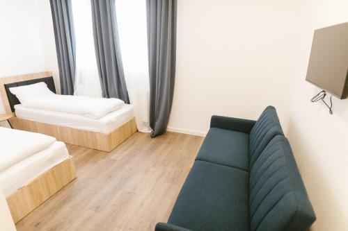 a living room with a couch and a tv at Pensiunea Arkara in Târgu-Mureş