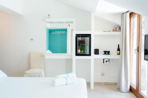 a white room with a refrigerator and a couch at Casa Clementina Marciano in Massa Lubrense