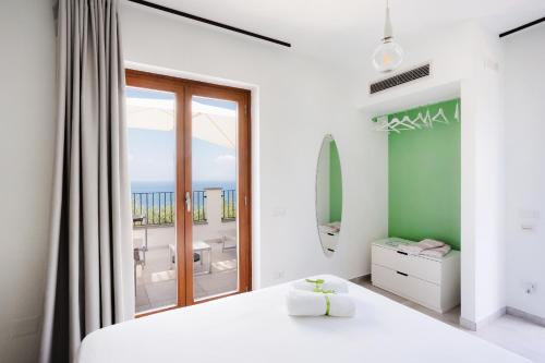a bedroom with a bed and a large window at Casa Clementina Marciano in Massa Lubrense