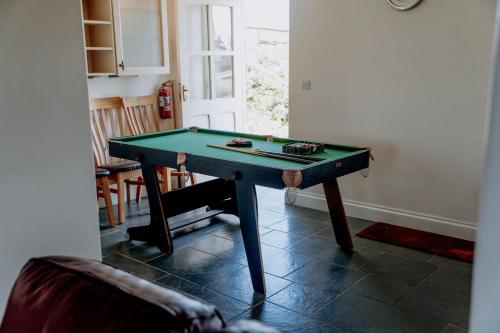 a ping pong table in a living room at Spacious Farmhouse Retreat with Hot Tub, sleeps 12 in Llawhaden