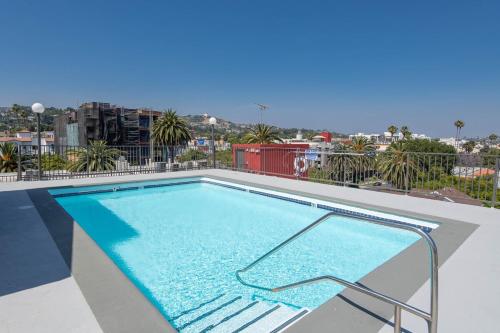 a swimming pool on the roof of a building at Modern Hollywood Apt Rooftop Pool & Skyline Views in Los Angeles