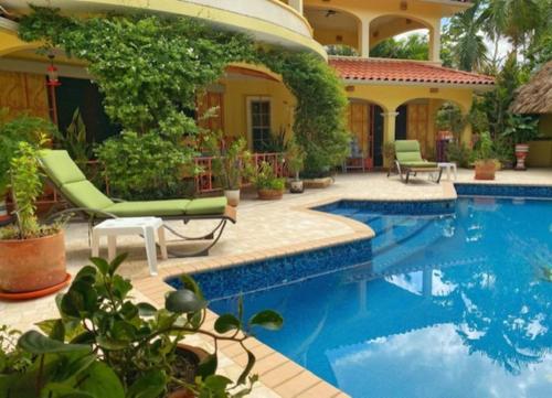 a house with a swimming pool in front of a house at Birders' Paradise with Private Pool & Epic Views in Santa Elena