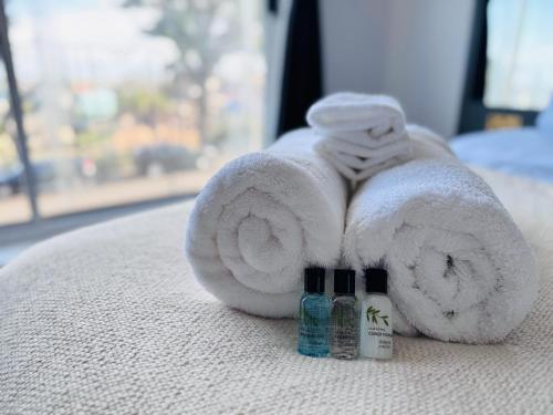 a towel and two bottles of soap on a bed at Pacific Hotel in Clacton-on-Sea