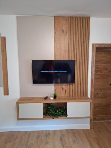 a living room with a flat screen tv on a wall at Apartmani Park Cuprija in Ćuprija