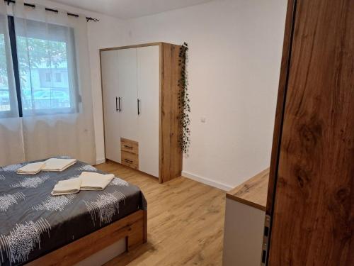 a bedroom with a bed and a dresser and a mirror at Apartmani Park Cuprija in Ćuprija