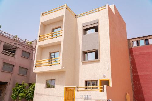 a building with a balcony on the side of it at Tifawine Stay Guest House Social Stay and Oceanview Rooms in Imsouane