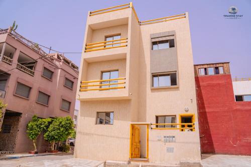 a building with yellow doors in front at Tifawine Stay Guest House Social Stay and Oceanview Rooms in Imsouane