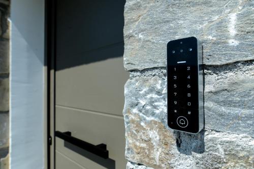 a remote control on the side of a stone wall at Envy Seaside Suites,By IdealStay Experience in Heraklion