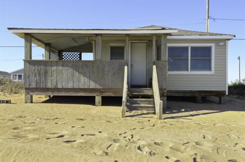 a tiny house with a porch on the beach at 4025 - Neaptide in Kitty Hawk