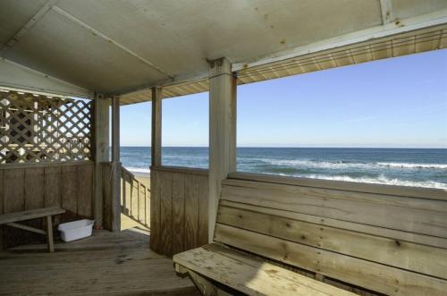 a wooden porch with a view of the ocean at 4025 - Neaptide in Kitty Hawk