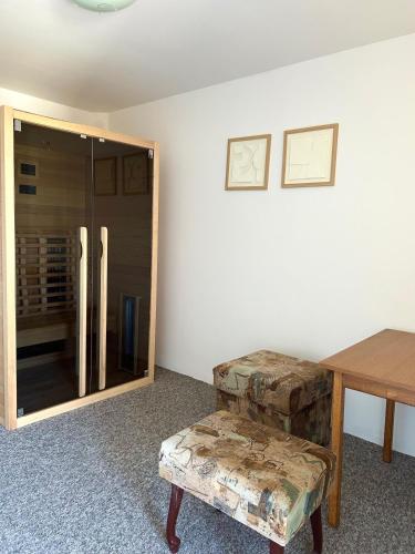 a room with a table and a glass refrigerator at Kuća za odmor Sofija in Beli Manastir