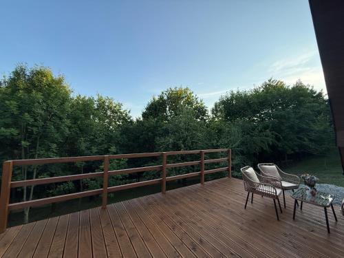 a wooden deck with two chairs and a table at Julianowe Wzgórze in Czchów