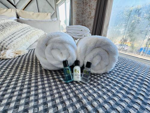 a bed with two towels and two bottles of shampoo at Pacific Hotel in Clacton-on-Sea