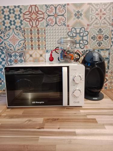 a microwave oven sitting on top of a kitchen floor at Rural apartment La Cantonada in Guardiola de Berguedà