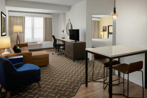 a hotel room with a living room with a desk at Residence Inn New Rochelle in New Rochelle