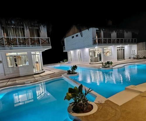 a large swimming pool in front of a building at Casa Palmar Oceanfront paradise in Zorritos in Zorritos