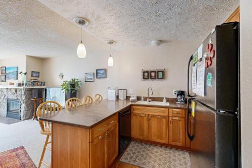 a kitchen with a refrigerator and a counter top at Brighton Condo #209 in Girdwood