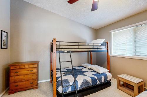 a bedroom with a bunk bed and a dresser at Brighton Condo #209 in Girdwood