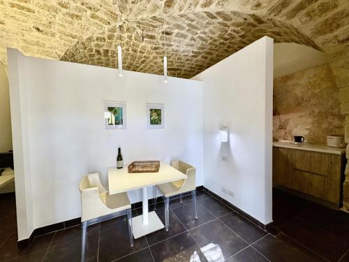 a dining room with white walls and a table and chairs at Torre Dantona Country Suites in Pozzallo