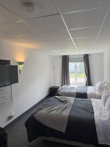 Postel nebo postele na pokoji v ubytování Hôtel Auberge St-Félicien
