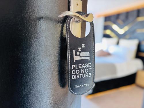 a metal door latch with a sticker on it at Pacific Hotel in Clacton-on-Sea
