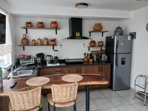 a kitchen with a wooden table and a refrigerator at Casa Termar in Machorra