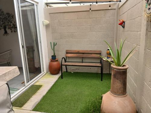 a patio with a bench sitting on the grass at Casa Termar in Machorra