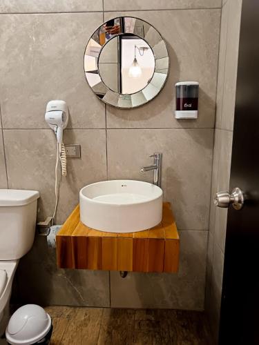 a bathroom with a sink and a mirror at Habitación arena, Paseo Durango in Durango