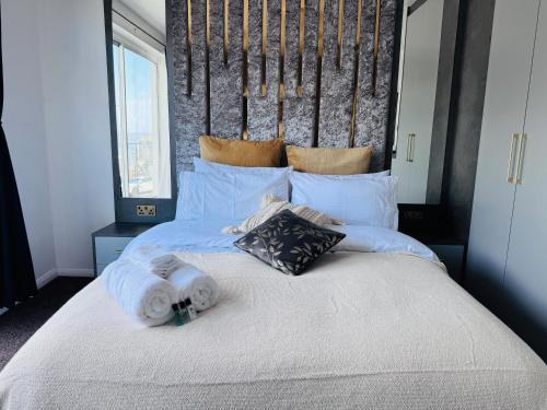 a large bed with towels on top of it at Pacific Hotel in Clacton-on-Sea