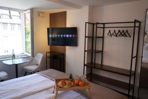 a bedroom with a bed with a tray of oranges on a table at Ferienwohnungen Vito's Apartments Ravensburg in Ravensburg
