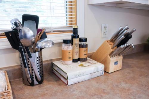 a kitchen counter with cooking utensils and bottles of wine at Walk To Beach And Downtown Lake Geneva! in Lake Geneva